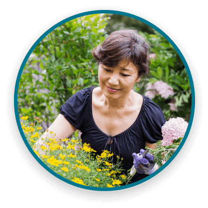 Woman smiling in an outdoor garden